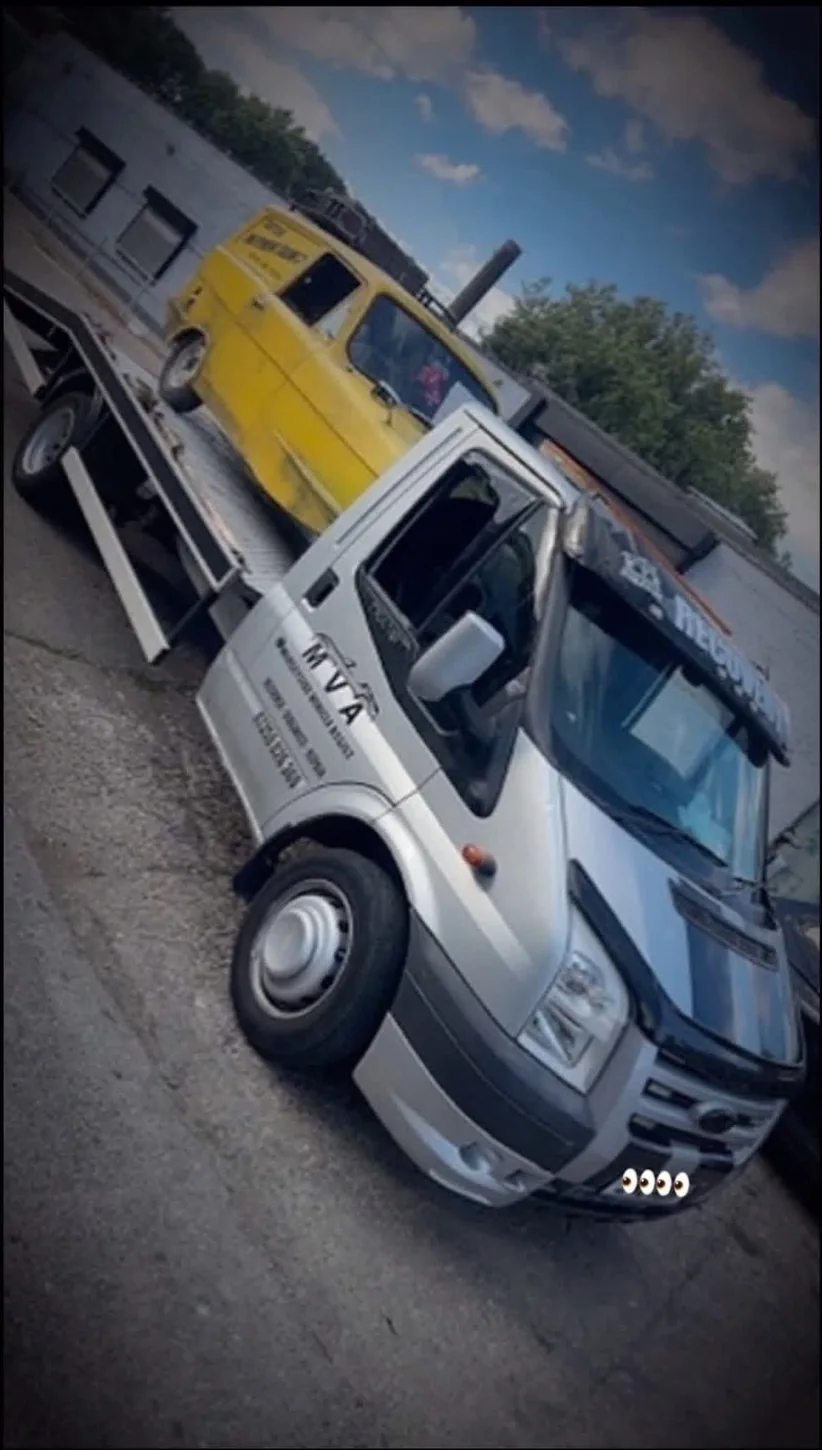 Merseyside Vehicle Assist recovery truck transporting a yellow vehicle